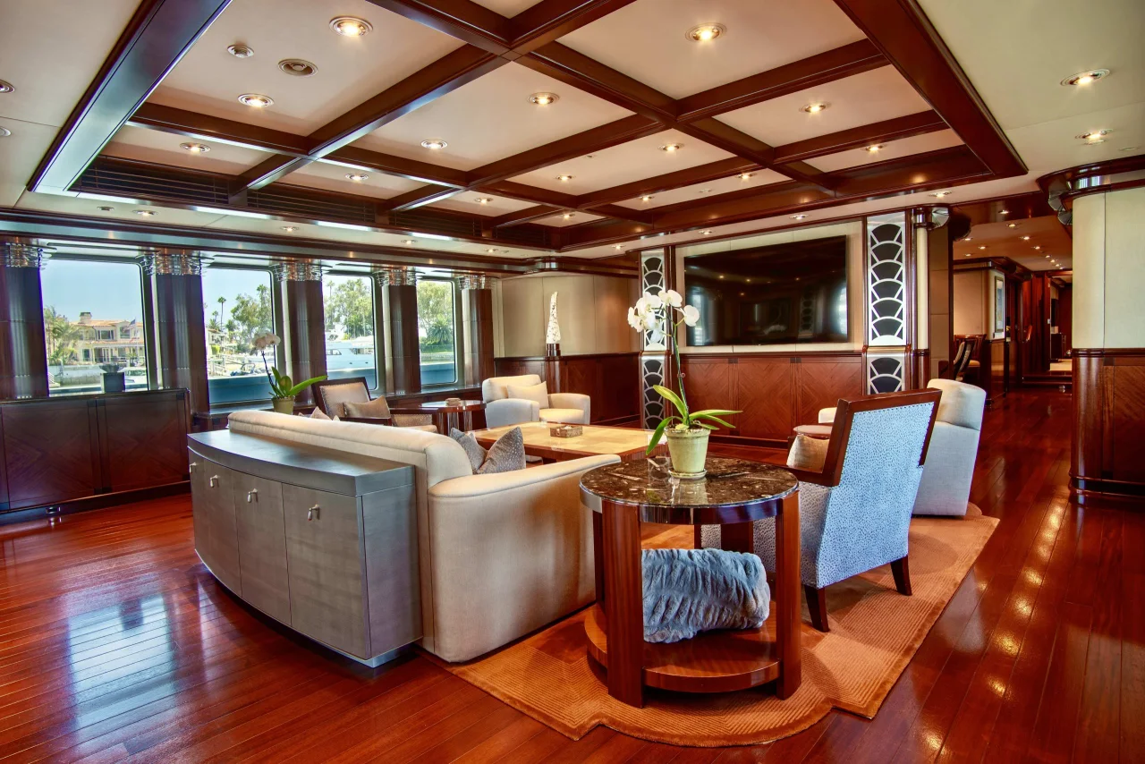 Cream sofas and polished wood furniture in a yacht salon